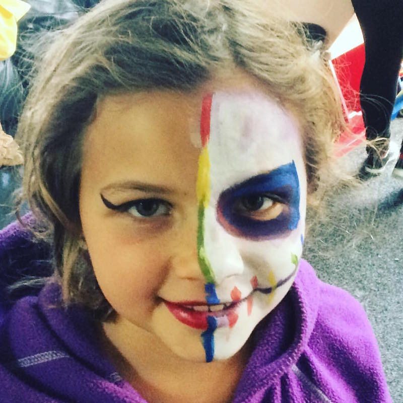 Alpha with her face painted at On the Corner